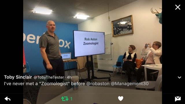 A tweet from Toby Sinclair reading “I've never met a ‘Zoomologist’ before”, beside a photo of Rob Aston presenting at a Zoom-Out workshop